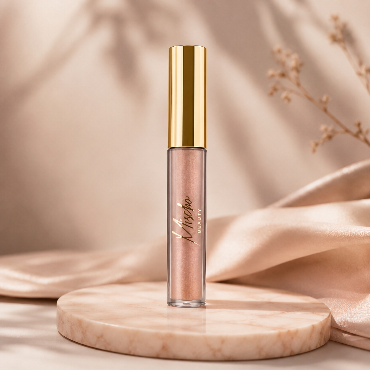 Lip gloss with gold cap on a beige platform against a soft beige background